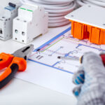 Repair, renovation, electricity, concept. Electrician working with electrical scheme.